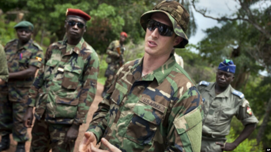 U.S. Army special forces Captain Gregory, 29, from Texas, center, who would only give his first name in accordance with special forces security guidelines, speaks with troops from the Central African Republic and Uganda, in Obo, Central African Republic,