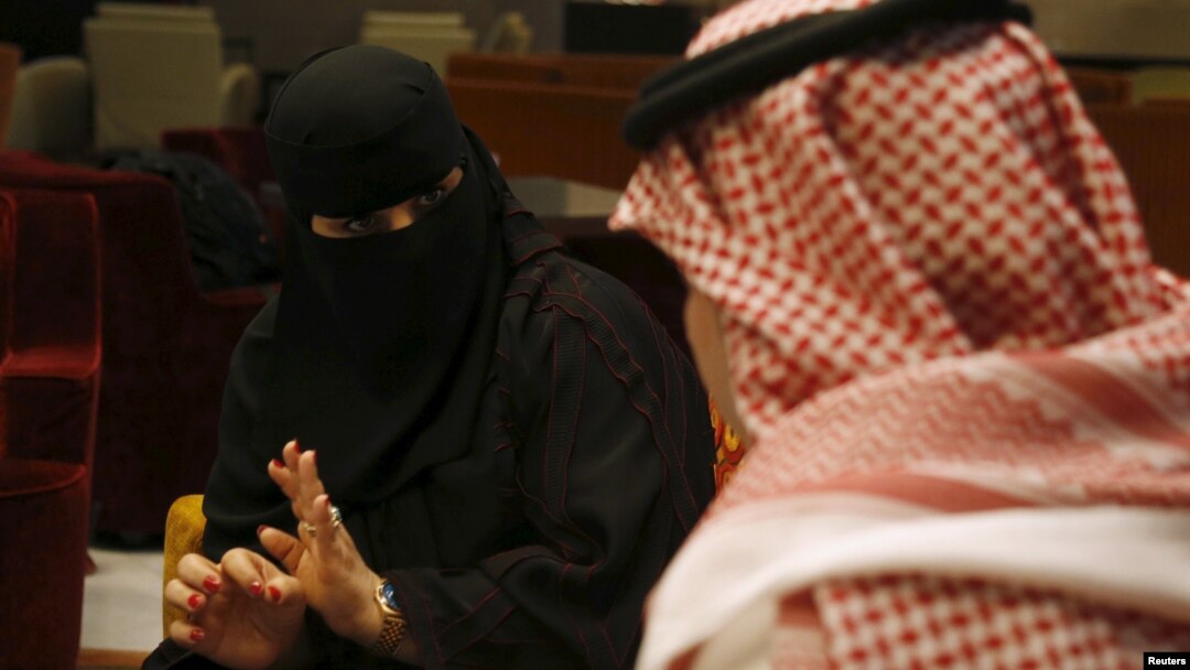 Saudi woman Fawzia al-Harbi, a candidate for local municipal council elections, gestures to one of her chaperones at a shopping mall in Riyadh November 29, 2015.