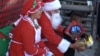Santa and Mrs. Claus distributed gifts to the kids at the Corps' annual holiday party. (M. O'Sullivan/VOA)