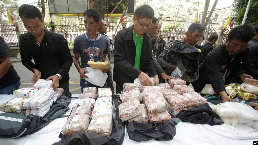 FILE - Thai policemen display intercepted drugs - 226 kilograms (498 pounds) of crystal meth and 8 kilograms (18 pounds) of heroin - during press a conference in Bangkok, Thailand, March 24, 2016. Thai police arrested 15 Malaysians as part of the operation.