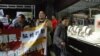 A female tourist from mainland China (right) tries to avoid the protesters. (Iris Tong, VOA)