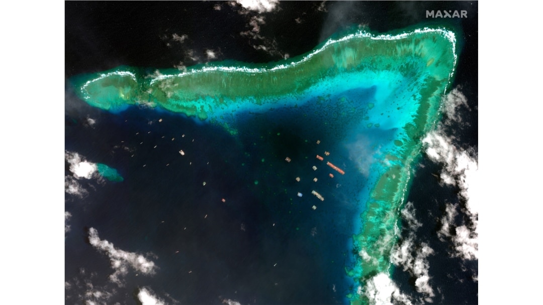 This satellite image provided by Maxar Technologies shows Chinese vessels at the Whitsun reef, in a disputed part of the South China Sea, March 23, 2021.