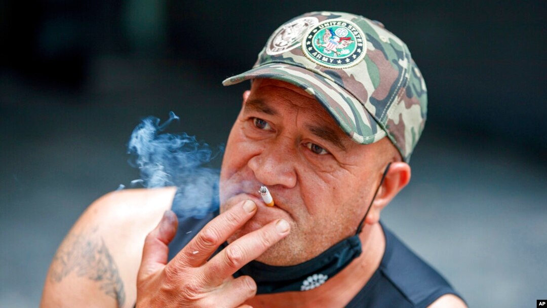 A man smokes in Auckland, New Zealand, Dec. 9, 2021. 