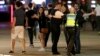 A police officer clears people away from the area near London Bridge after an incident in central London, late Saturday, June 3, 2017.