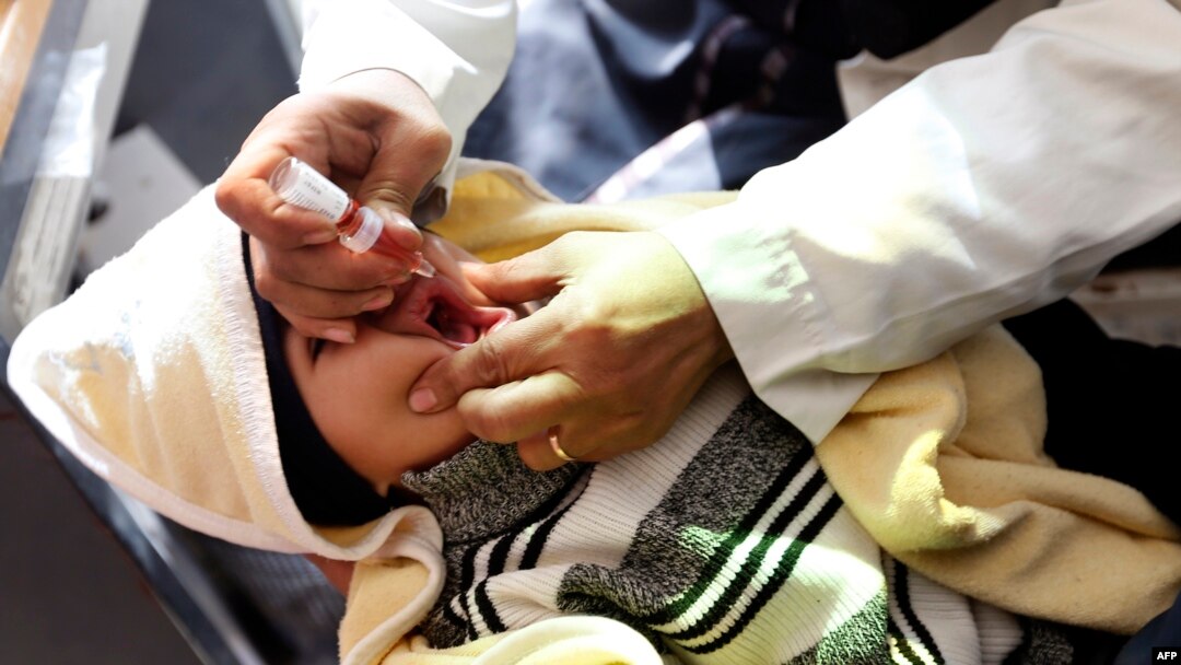 A child receives a polio vaccination on the outskirts of the Yemeni capital Sana'a, on Dec. 11, 2017.