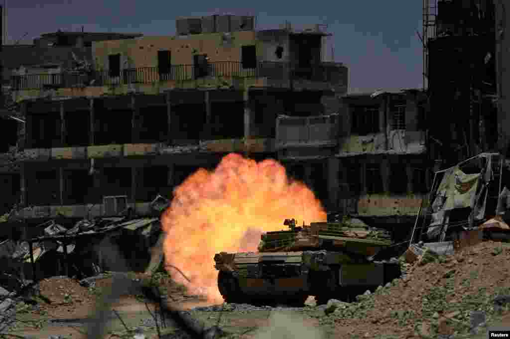 A tank of the Emergency Response Division fires at Islamic State militant in the old city of Mosul, Iraq.