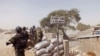 FILE - Cameroon soldiers stand guard at a lookout post near the village of Fotokol as they take part in operations against the Islamic extremists group Boko Haram, Feb. 25, 2015.