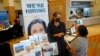 FILE - Marriott human resources recruiter Mariela Cuevas, left, talks to Lisbet Oliveros, during a job fair at Hard Rock Stadium, in Miami Gardens, Florida, Sept. 3, 2021.