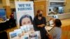FILE - Marriott human resources recruiter Mariela Cuevas, left, talks to Lisbet Oliveros, during a job fair at Hard Rock Stadium, in Miami Gardens, Florida, Sept. 3, 2021.
