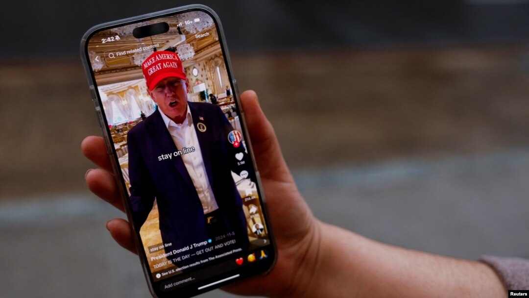 A woman shows her smartphone, displaying the @realdonaldtrump TikTok page, in Washington, Jan. 19, 2025.