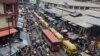 FILE - In this photo taken June 20, 2016, pedestrians shop at a market in Lagos, Nigeria.