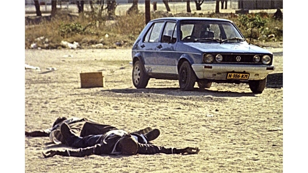 FILE - Two bodies of rebel insurgents lie in a street after sporadic gunfire in the Caprivi strip, Namibia, Aug. 3, 1999.