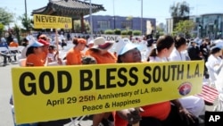 People take part in a rally and peace parade in Los Angeles' Koreatown, sponsored by the Korean-American community with participation by many ethnic groups, on the 25th anniversary of riots that erupted after the 1992 acquittal of four white police office