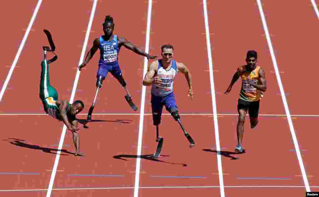 Ntando Mahlangu of South Africa falls during a heat of the men's 100 meter during IAAF World ParaAthletics Championships.