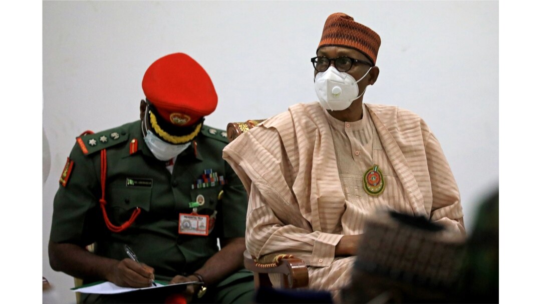 Nigerian President Muhammadu Buhari looks on after security forces rescued schoolboys at the Government house in Katsina, Nigeria, Dec. 18, 2020.